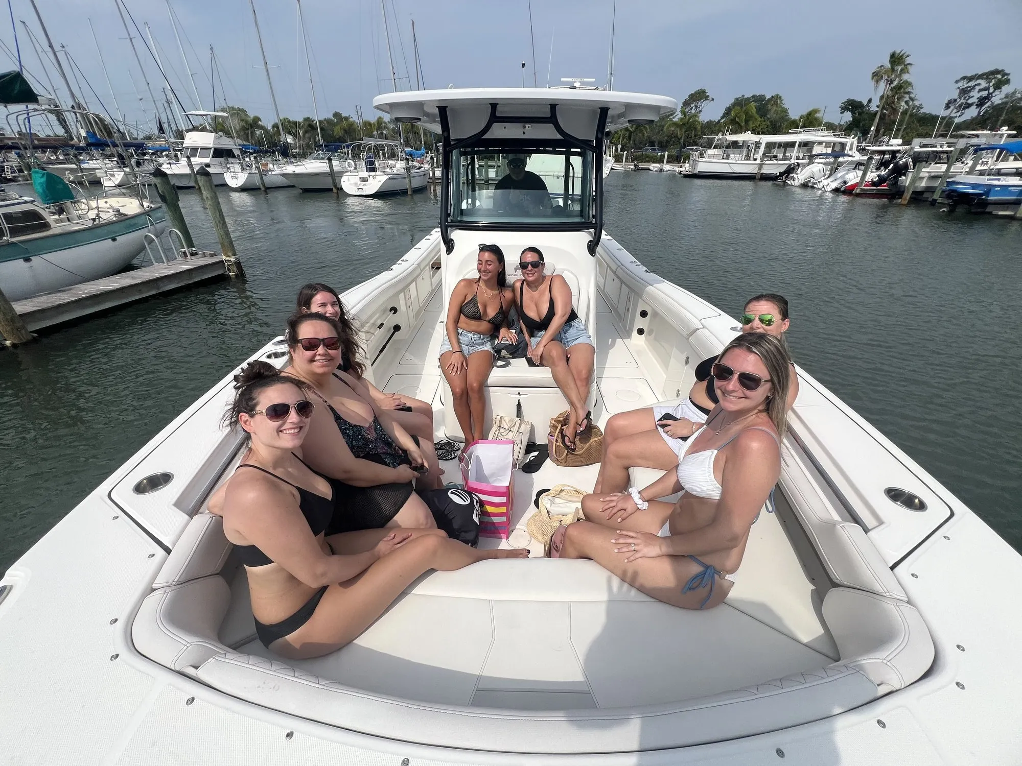 Celebration group relaxing on the bow of Phat Kat at the marina before a Gulf day trip