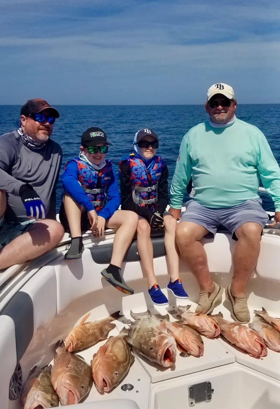 Family anglers with their red snapper catch aboard Phat Kat